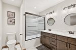 Shower tub combo and double vanity in this shared bathroom upstairs